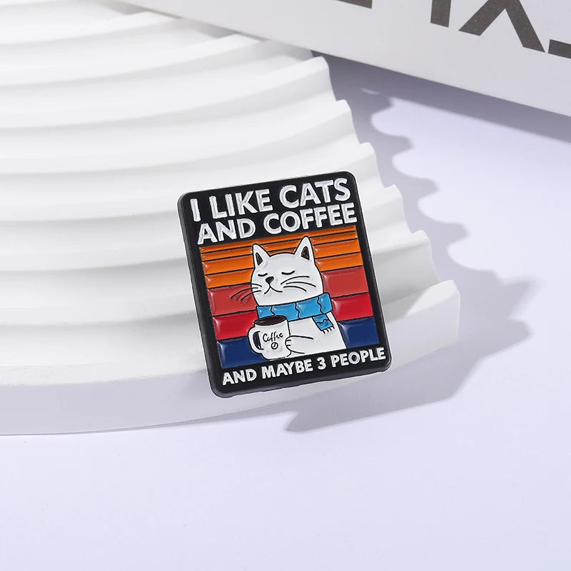 Enamel pin with 'I Like Cats and Coffee and Maybe 3 People' text and a cat illustration on a white background.