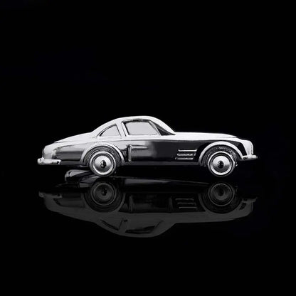 Black and white model car on a reflective black surface