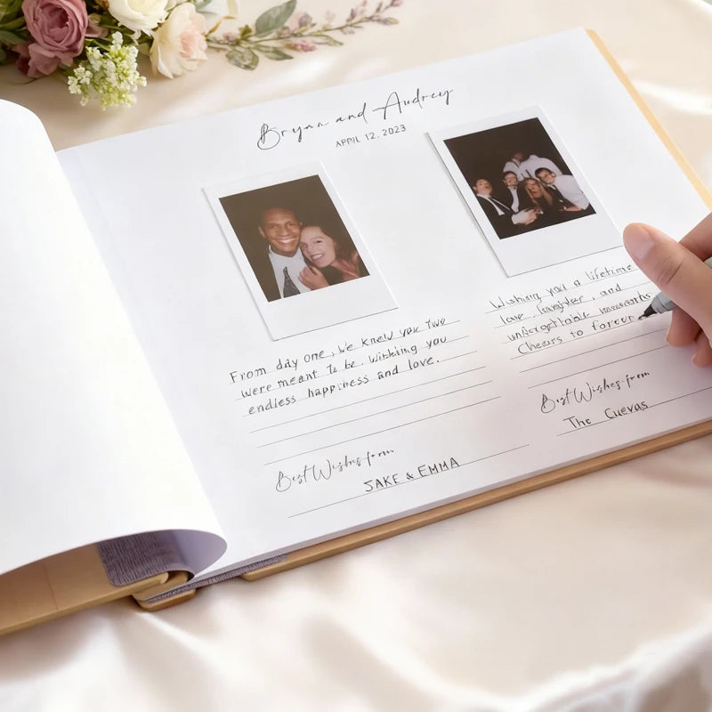 Personalized wedding album with photos and text on a white surface with flowers.