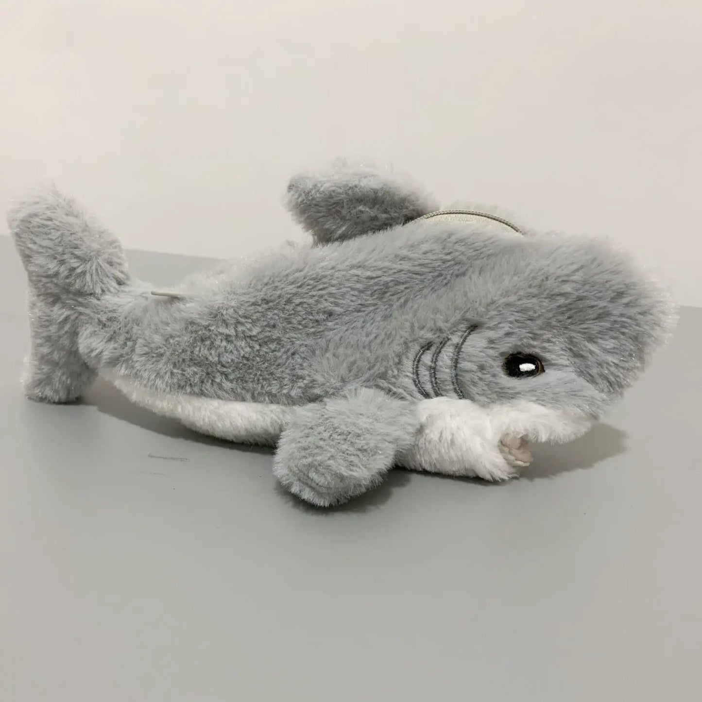 Plush shark toy on a light gray background