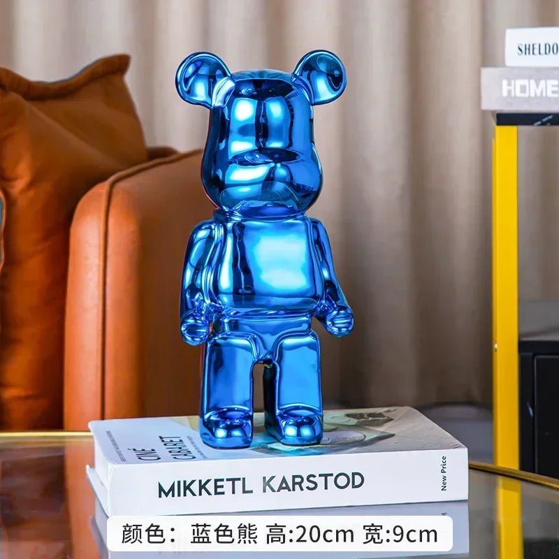 Blue bear-shaped object on a stack of books with a blurred background