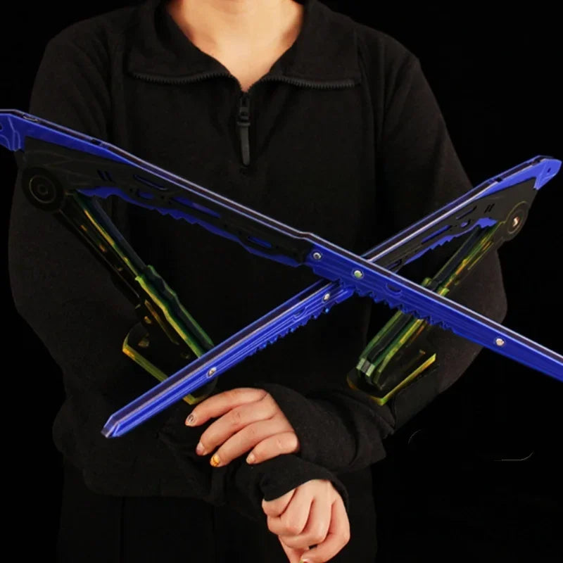 Person holding a blue and green folding stand against a black background