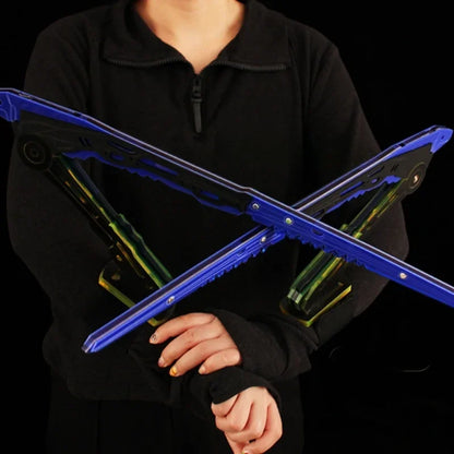 Person holding a blue and green folding stand against a black background