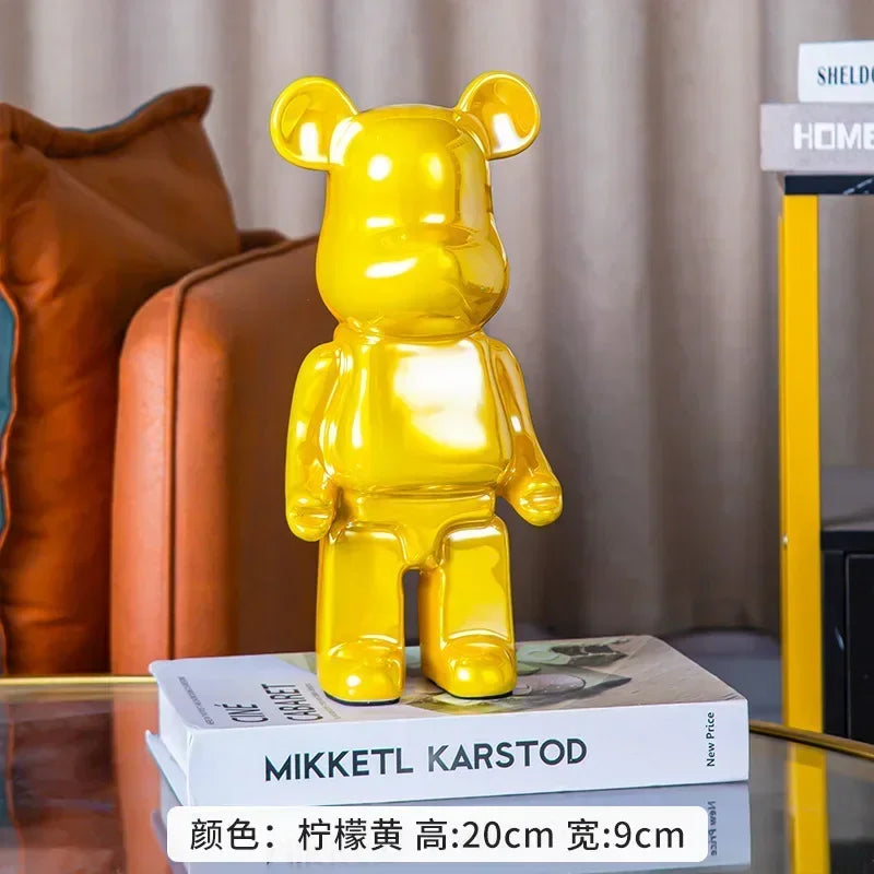 Yellow bear-shaped object on a stack of books with a blurred background