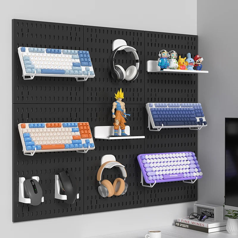 Black pegboard wall with various computer accessories and figurines