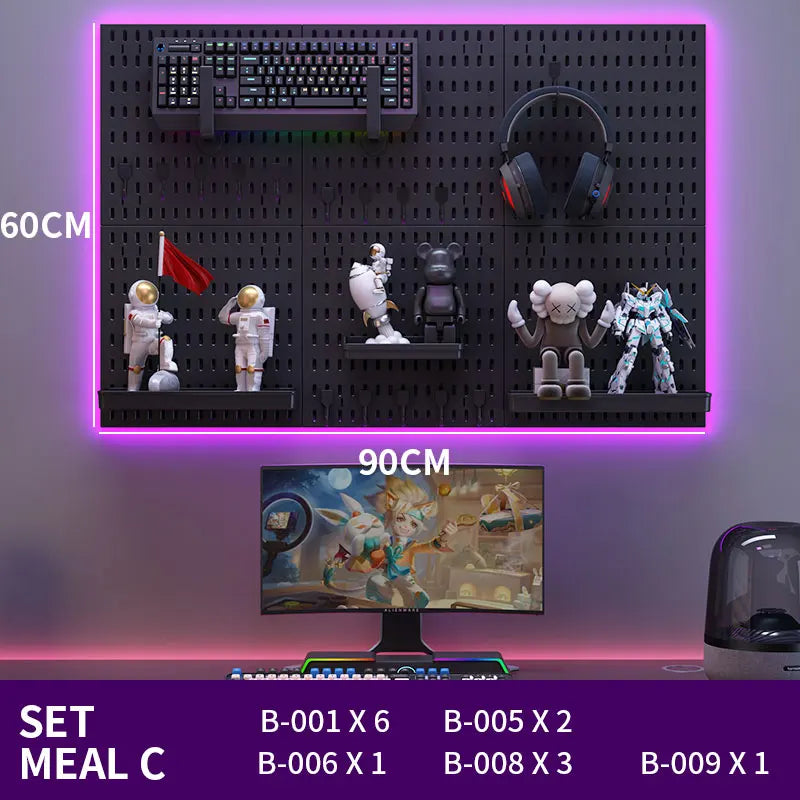 Gaming setup with monitor, keyboard, mouse, and figurines on a pegboard wall.