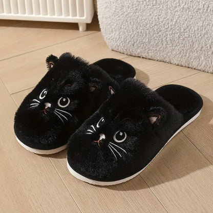 Black cat-shaped slippers on a wooden floor