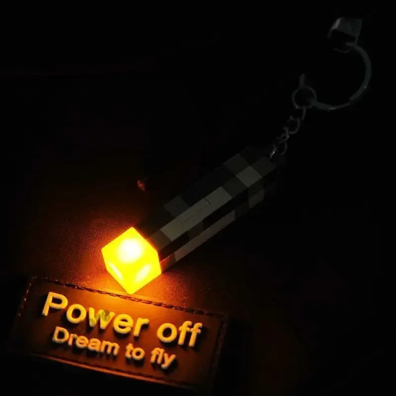 Small light-emitting device with 'Power off Dream to fly' text on a dark background