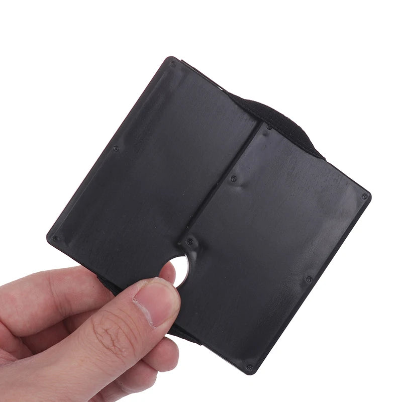 Black rectangular object held by a hand on a white background