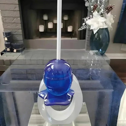 Blue glass object on a white stand in a modern living room setting