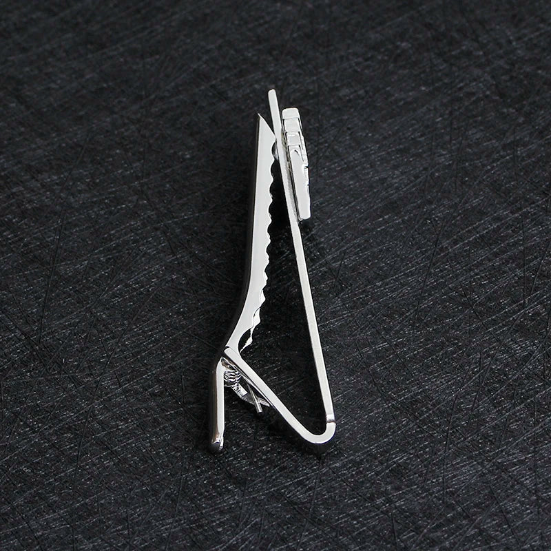 Metallic clip on a textured black surface