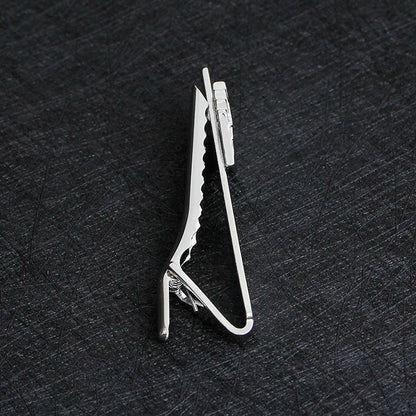 Metallic clip on a textured black surface