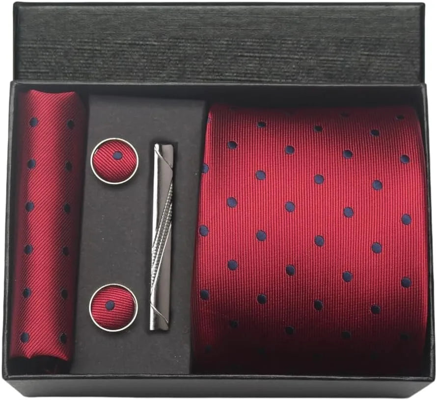 Red polka dot tie set with pocket square, cufflinks, and tie clip in a black box.