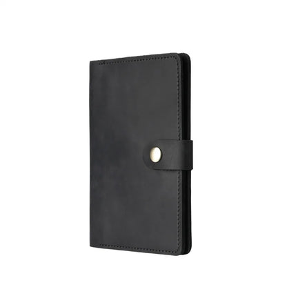 Black leather notebook with a strap on a white background