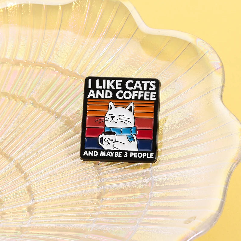 Enamel pin with a cat illustration and text on a yellow shell background