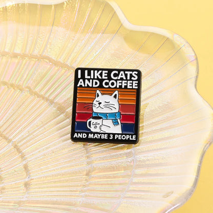 Enamel pin with a cat illustration and text on a yellow shell background