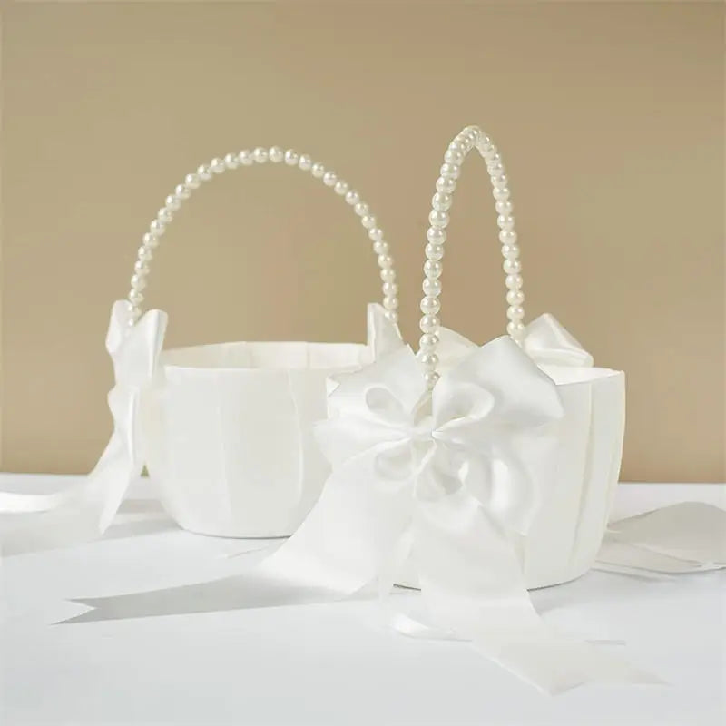 White flower girl basket with pearl handle on a beige background