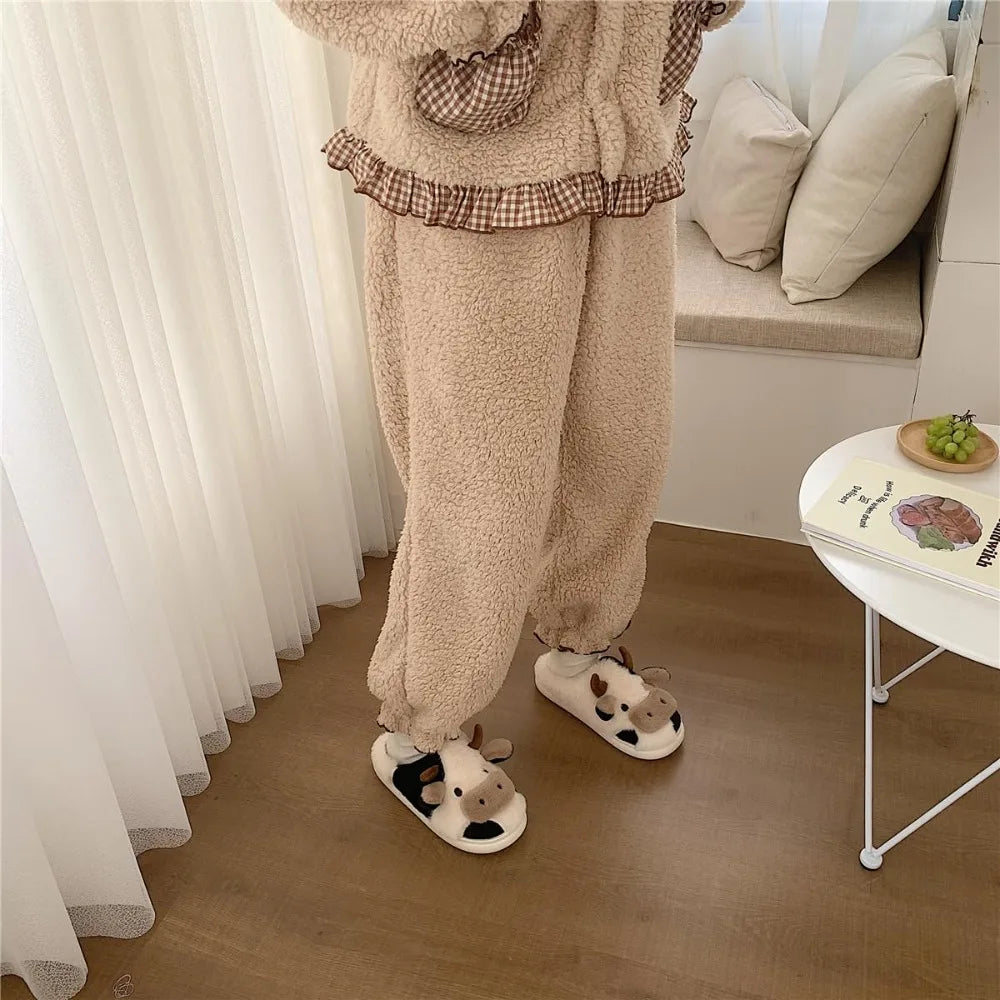 Person wearing a cozy outfit with fluffy pants and slippers in a home setting.