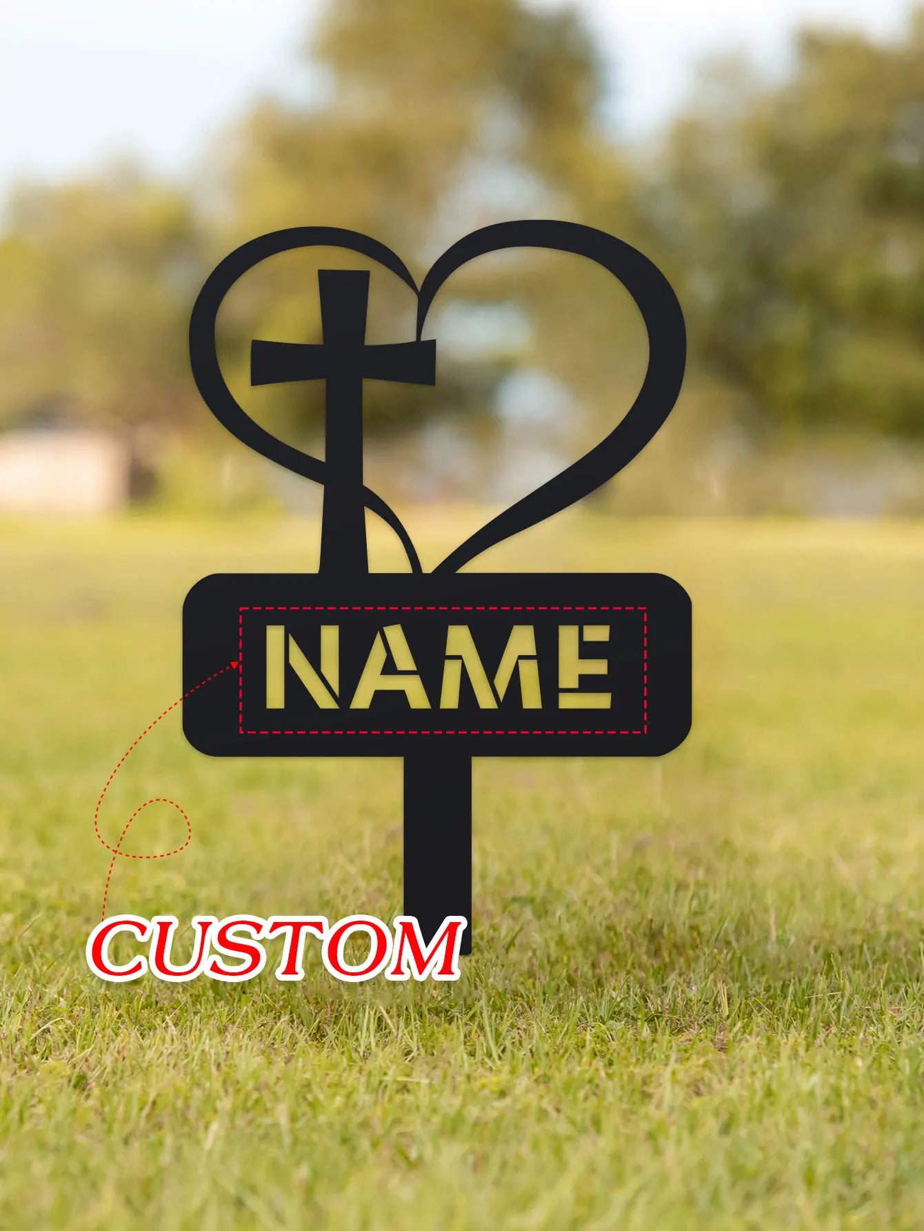 Decorative metal sign with cross and heart design on grass