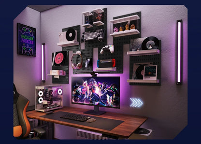 Gaming setup with computer monitor, desk, and shelves with decorative items in a room.