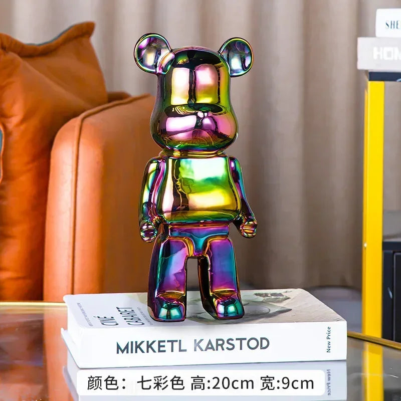 Multicolored bear-shaped figurine on a book with a blurred background