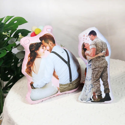 Two decorative pillows with printed images of a couple on a white surface.
