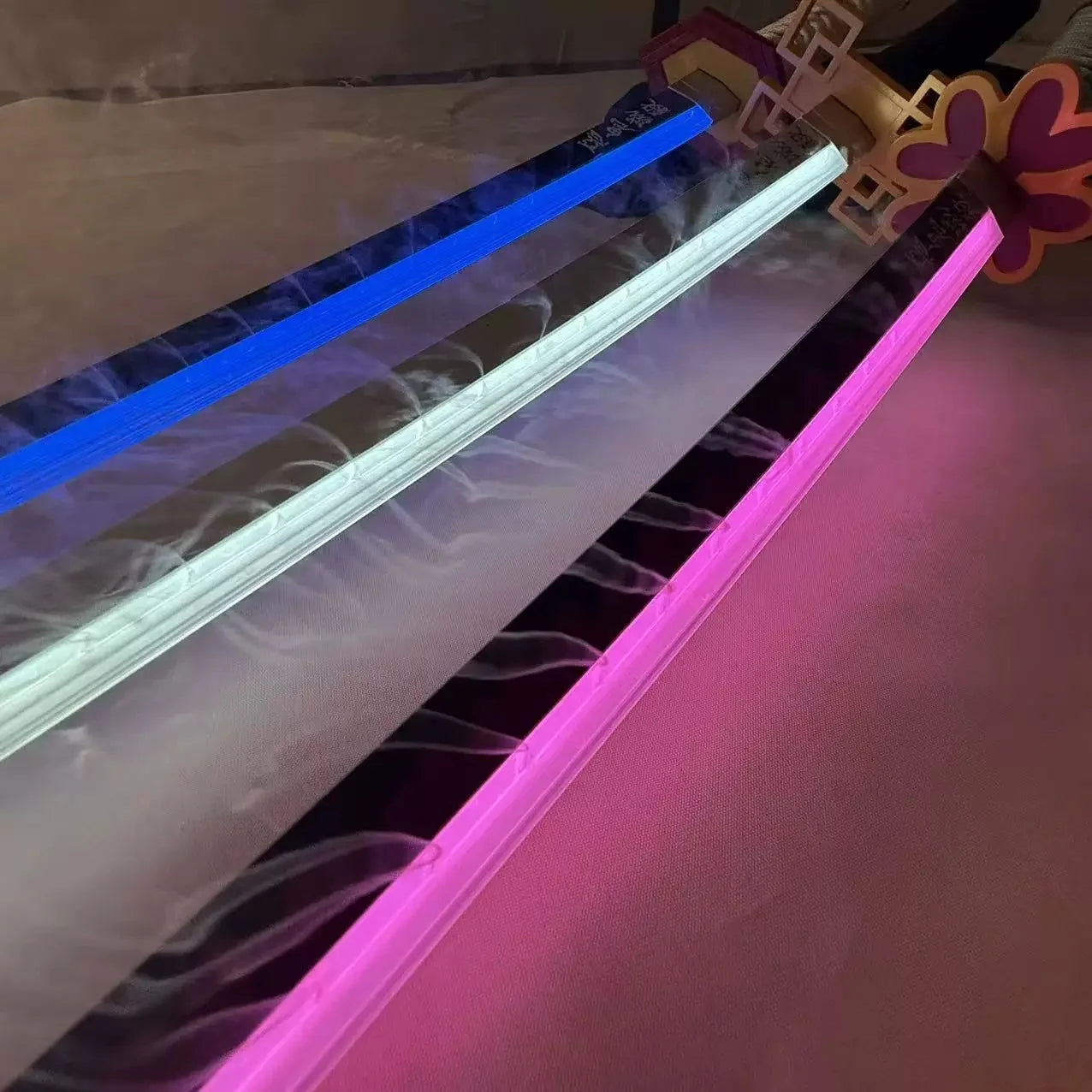 Neon light strips in blue, white, and pink on a clear background