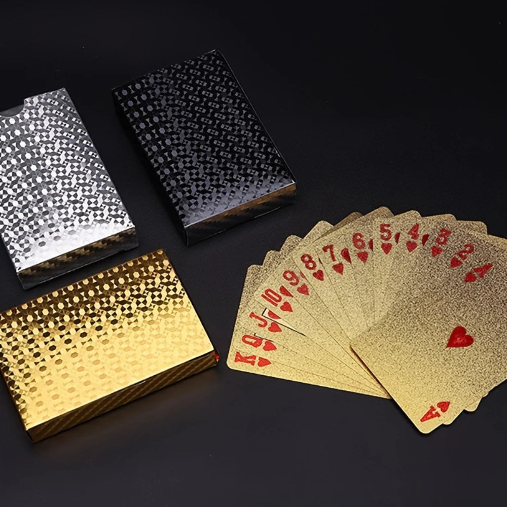Gold and silver playing card boxes with gold playing cards on a black background
