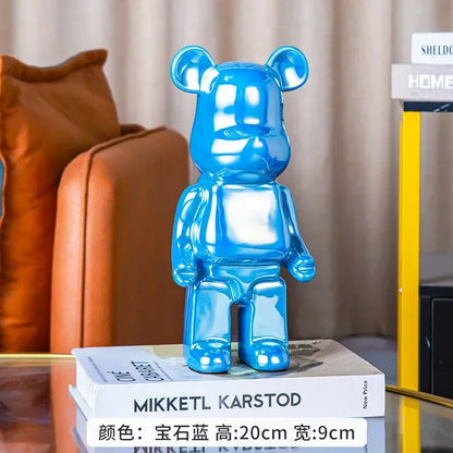 Blue bear-shaped object on books with a blurred background