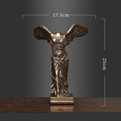 Bronze statue of a winged figure with dimensions on a dark background