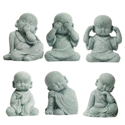 Set of six stone statues of a meditating monk with different poses on a white background