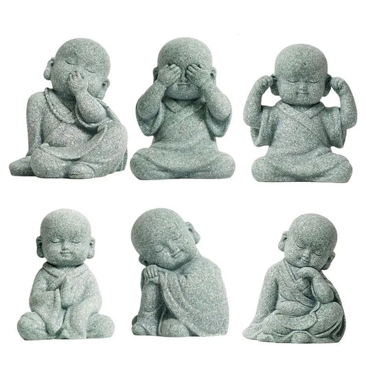 Set of six stone statues of a meditating monk with different poses on a white background