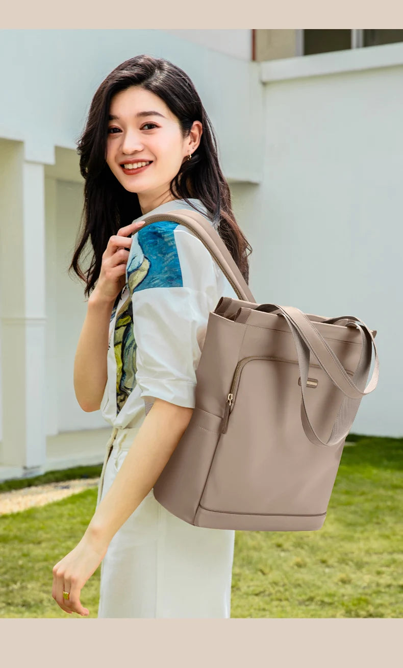 Woman holding a beige tote bag outdoors