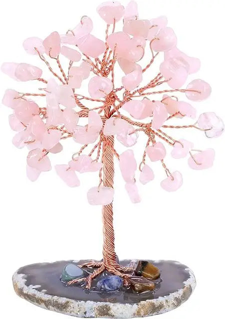 Decorative tree made of pink beads on a stone base with a white background