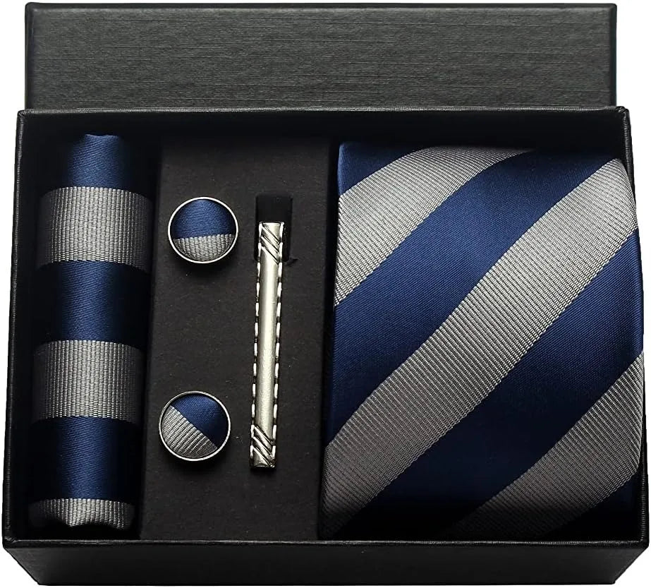 Men's tie set with striped tie, pocket square, cufflinks, and tie clip in a black box.