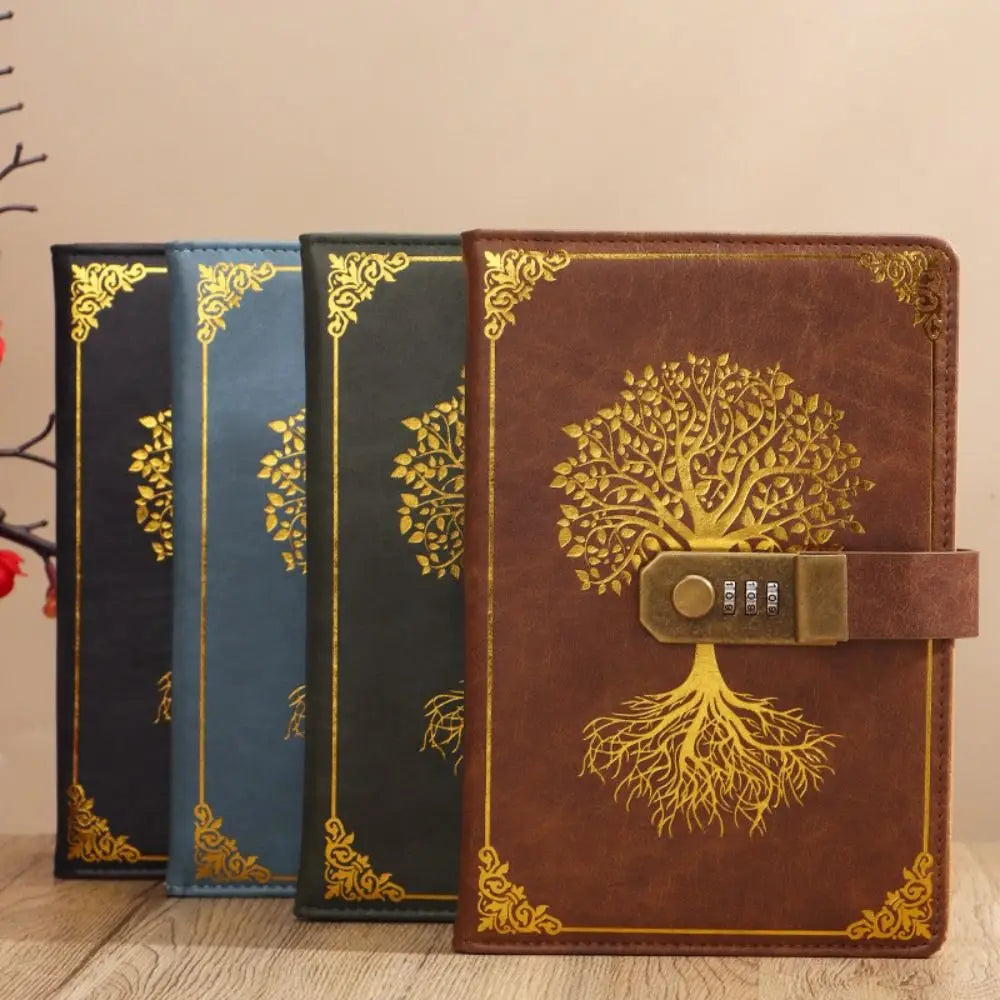 Three decorative notebooks with tree designs on a wooden surface.