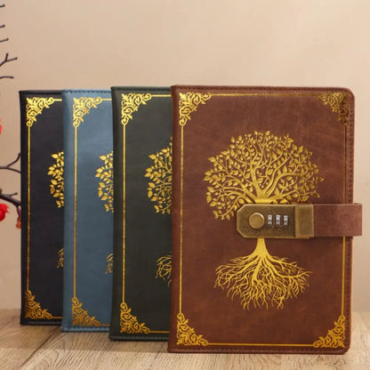 Three decorative notebooks with tree designs on a wooden surface.