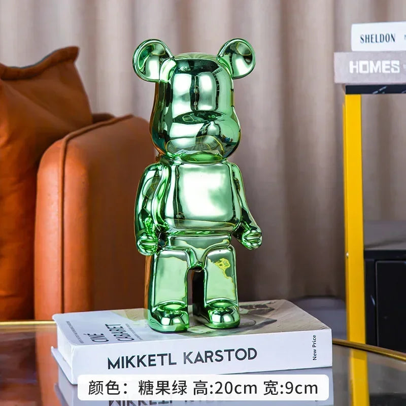 Green bear-shaped figurine on books with a blurred background