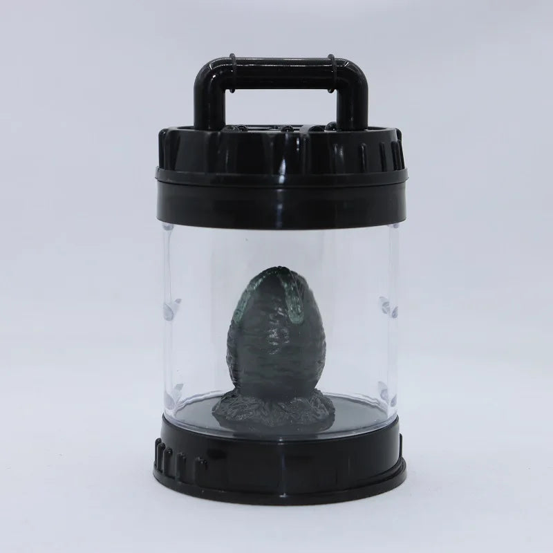 Black and clear container with a black object inside on a white background