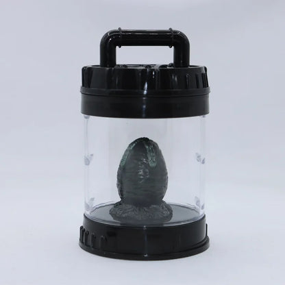 Black and clear container with a black object inside on a white background