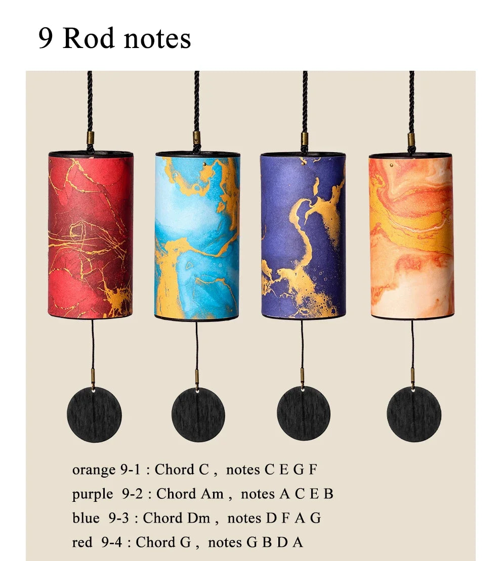 Four colorful cylindrical wind chimes with marbled patterns on a beige background.