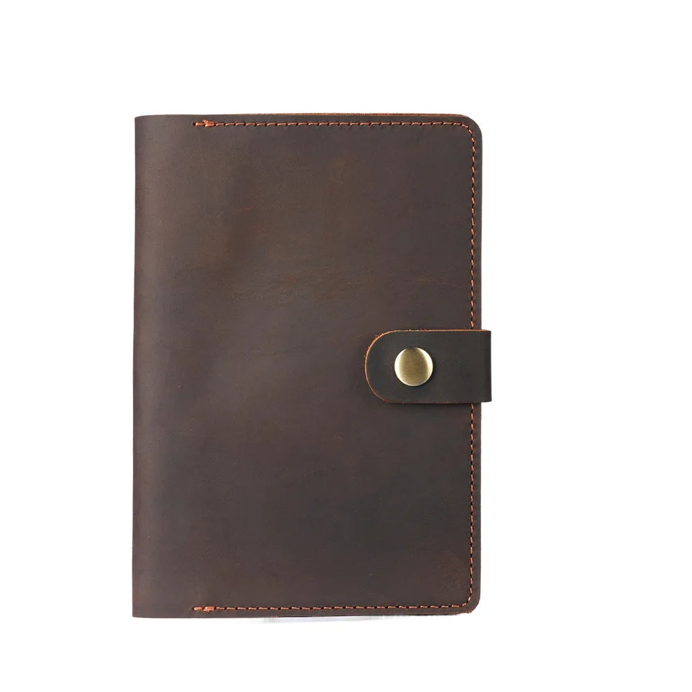 Brown leather notebook with a gold buckle on a white background