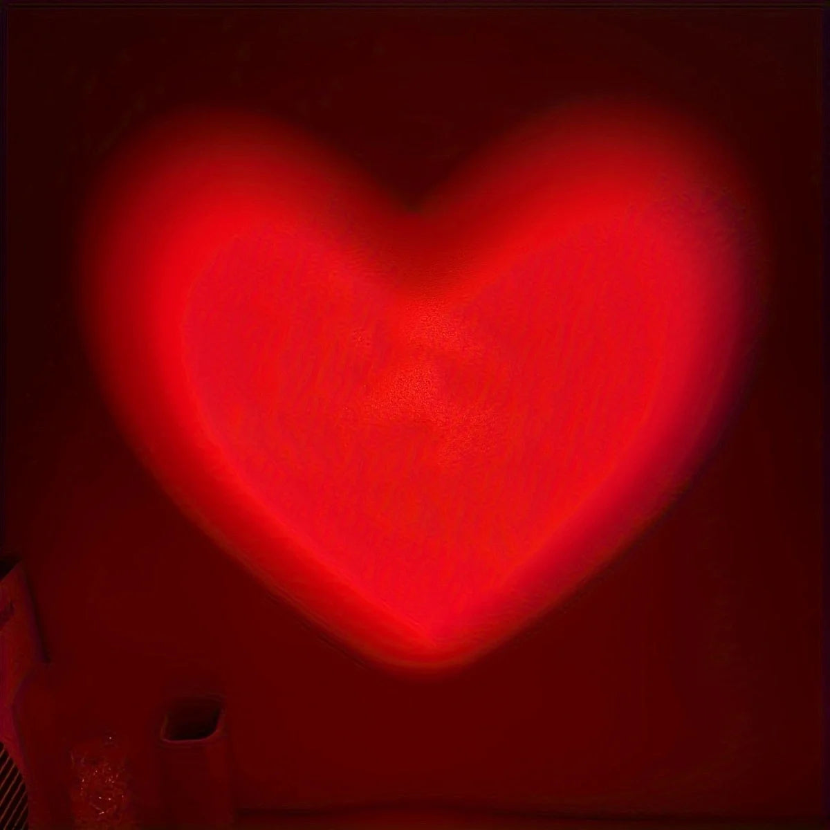 Red heart-shaped light on a dark background