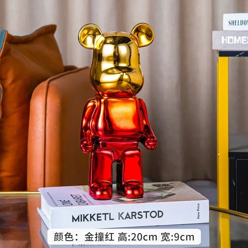 Gold and red bear-shaped figurine on a book with a blurred background