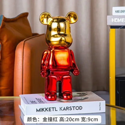 Gold and red bear-shaped figurine on a book with a blurred background