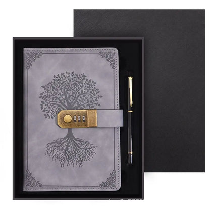 Gray leather notebook with tree design and combination lock, accompanied by a pen, in a black box.