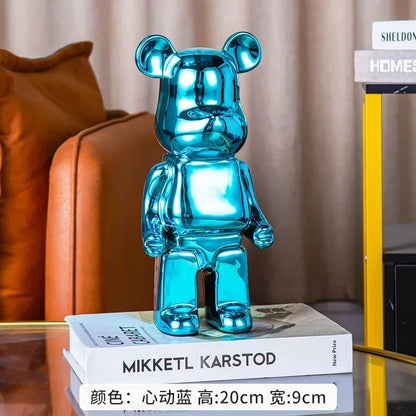 Blue teddy bear figurine on a stack of books with a blurred background