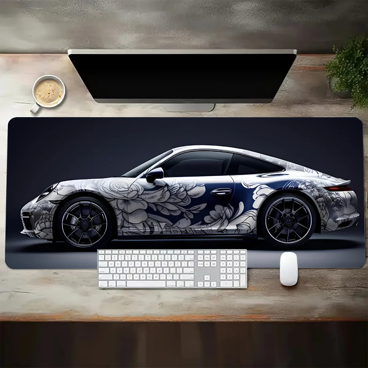 Desk setup with a car-themed mouse pad featuring a Porsche design, keyboard, and mouse.