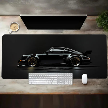 Desk setup with a large desk mat featuring a car design, keyboard, and mouse.