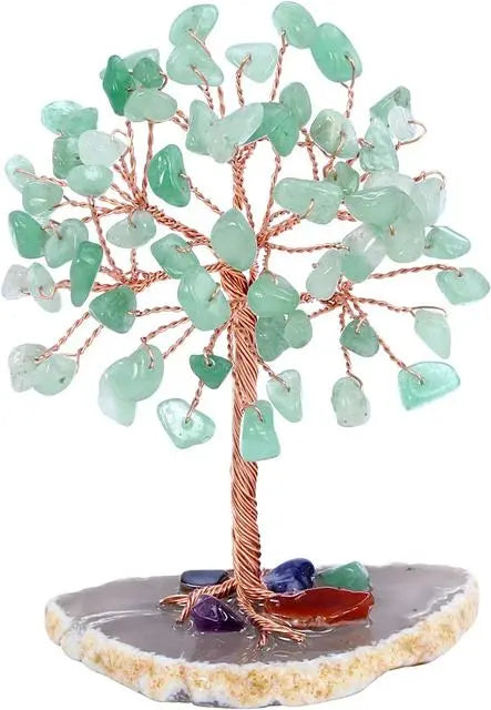 Decorative crystal tree with green stones on a white background